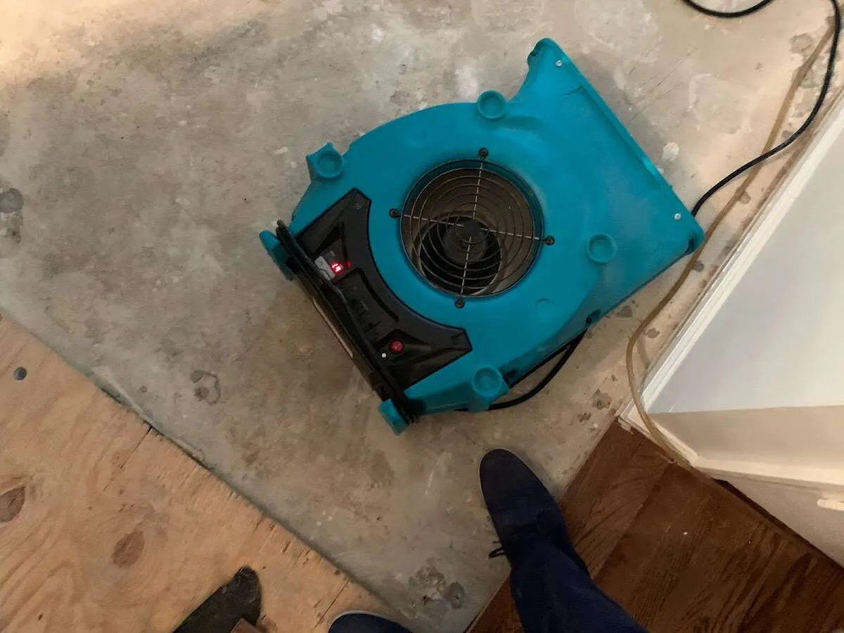 Air mover drying subfloor during Leak Detection & Repair in Fairlawn